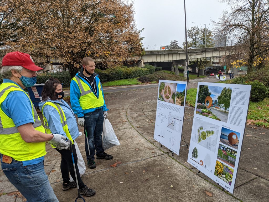 Volunteers at the park read signage about the park's redesign